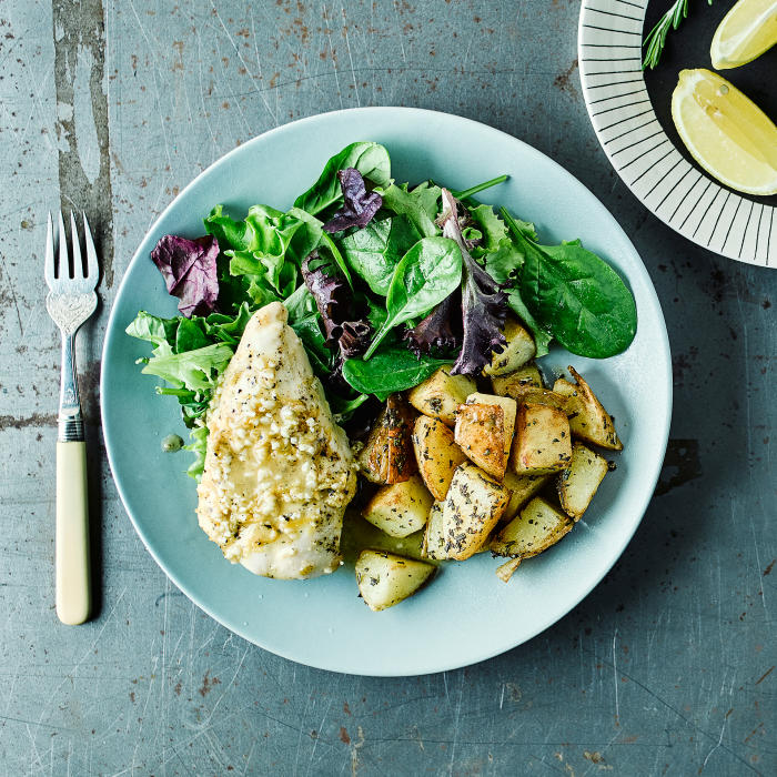 Chicken with Crisp Rosemary Potatoes Lemon pepper chicken with crispy rosemary potatoes on a light blue plate.